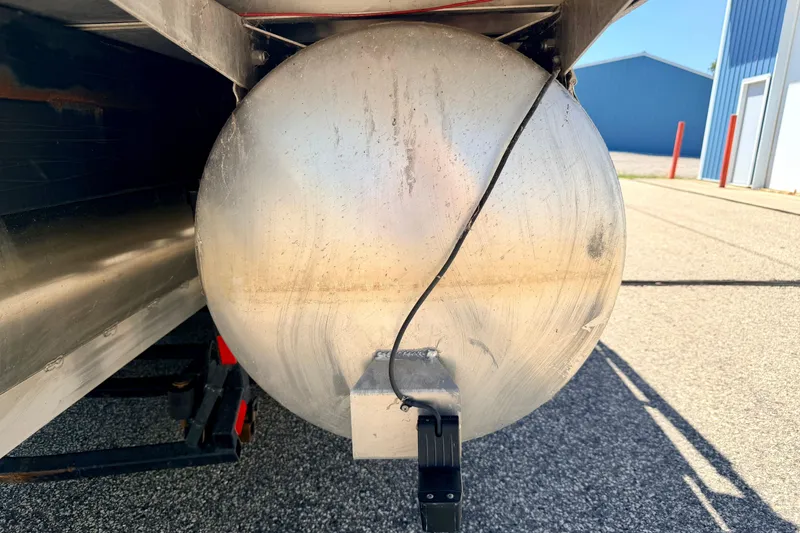 Slide: The Image of Close-up of a 2015 Manitou 25 SES BENCH pontoon's aluminum hull on a sunny day. - 97