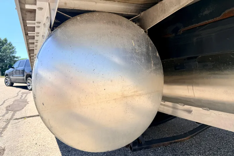 Slide: The Image of Close-up of a 2015 Manitou 25 SES BENCH pontoon's underside with a visible metal component. - 96