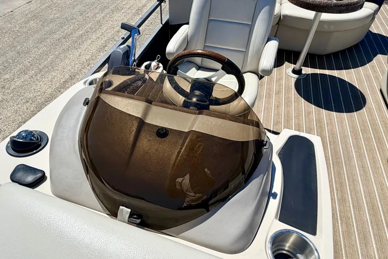 Slide: The Image of 2015 Manitou 25 SES BENCH boat interior with steering wheel and seating. - 86