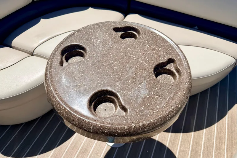 Slide: The Image of Round table with cup holders on a 2015 Manitou 25 SES BENCH boat. - 55