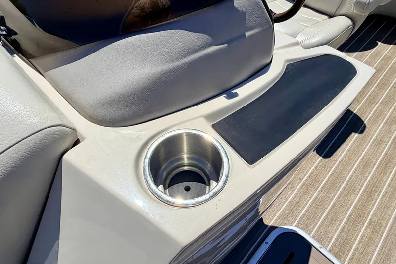 Slide: The Image of 2015 Manitou 25 SES BENCH boat interior with cup holder and seating. - 85