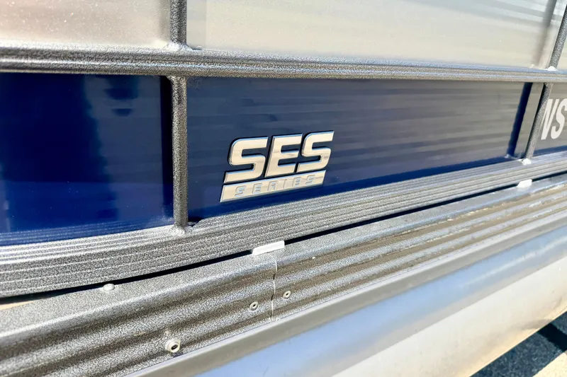 Slide: The Image of Close-up of 2015 Manitou 25 SES BENCH boat with SES Series logo. - 15