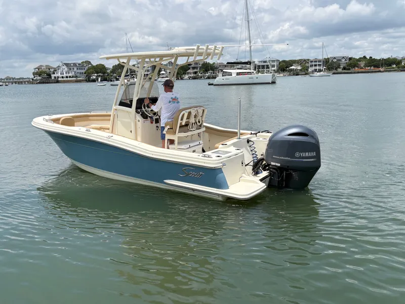 Slide: The Image of A 2019 Scout 215 XSF boat on calm water with a Yamaha outboard motor. - 3