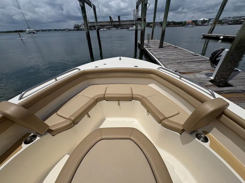 Slide: The Image of The image shows the bow of a 2019 Scout 215 XSF boat with beige cushions. - 34