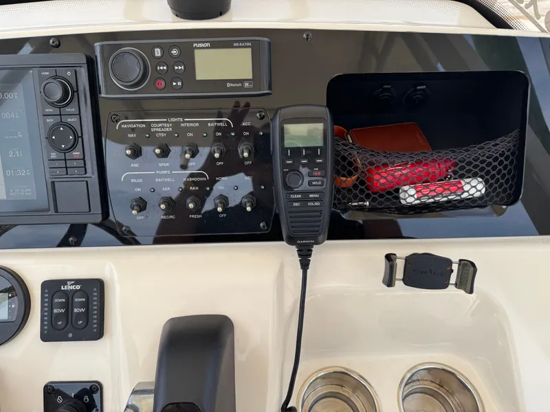 Slide: The Image of The image shows the dashboard of a Scout 215 XSF boat with various instruments and controls. - 11