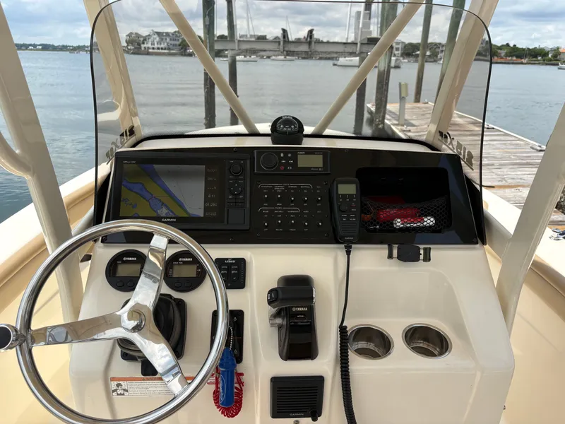 Slide: The Image of The image shows the helm of a 2019 Scout 215 XSF boat with navigation system and controls. - 16