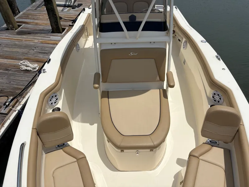 Slide: The Image of The image shows the cockpit of a 2019 Scout 215 XSF boat with beige seating. - 33