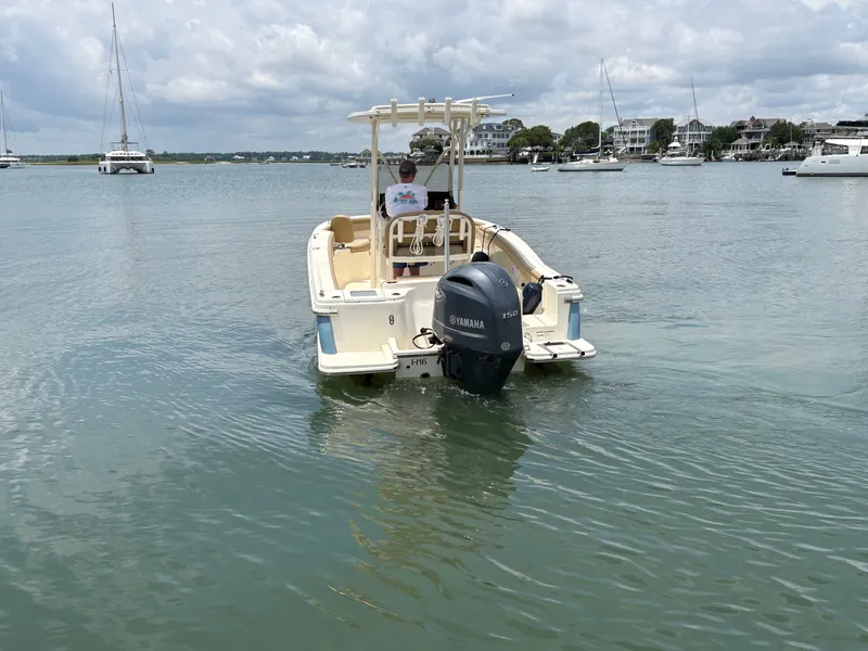 Slide: The Image of A 2019 Scout 215 XSF boat on calm water. It features a Yamaha outboard motor. - 5