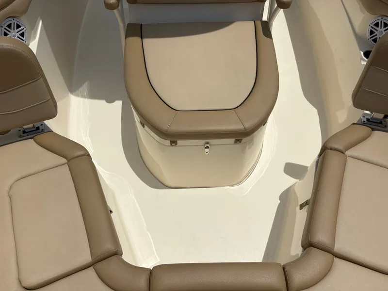 Slide: The Image of The image shows the beige upholstery in the cockpit of a 2019 Scout 215 XSF boat. - 35