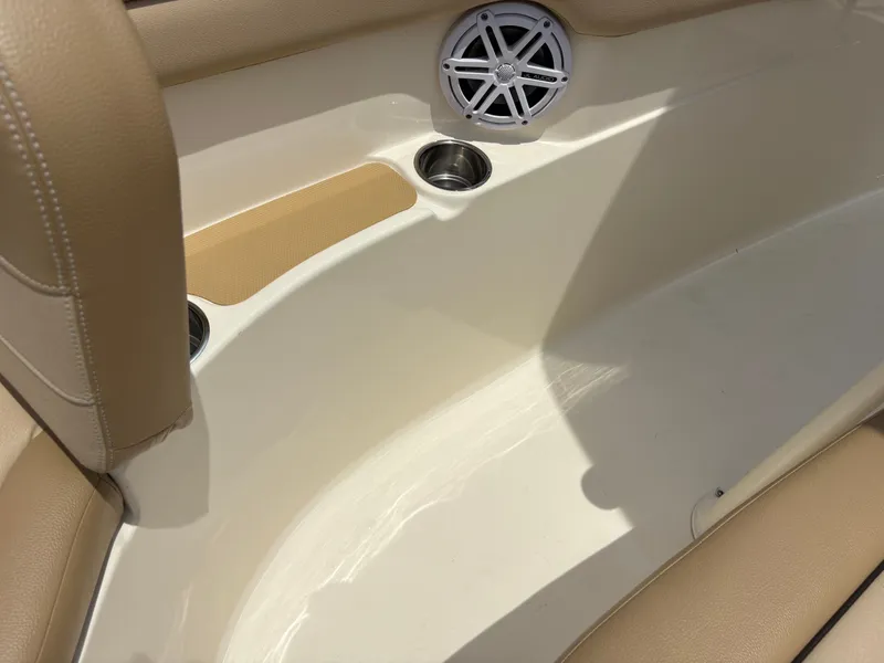 Slide: The Image of Close-up of a boat interior with beige upholstery, speaker, and cup holders. - 39