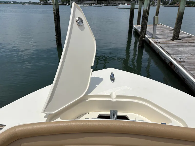 Slide: The Image of A 2019 Scout 215 XSF boat is docked. The bow area is visible. - 31