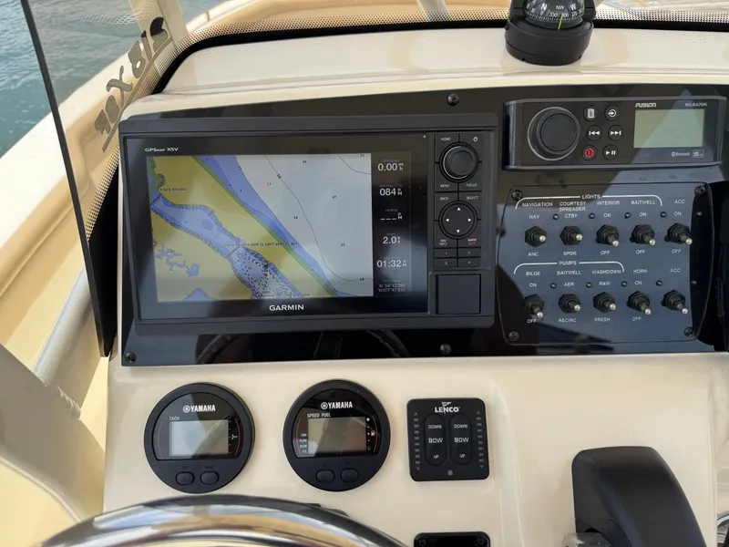 Slide: The Image of The image shows the dashboard of a Scout 215 XSF boat with navigation system and instruments. - 13