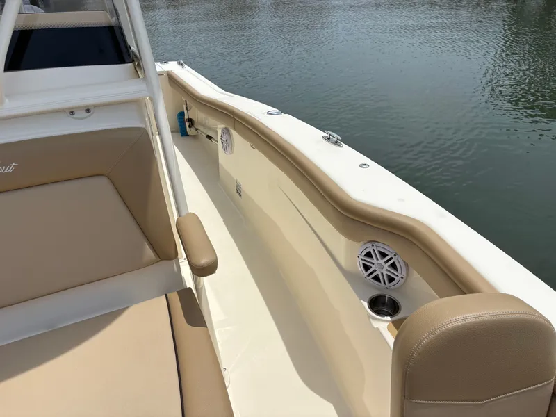 Slide: The Image of The image shows the cockpit of a 2019 Scout 215 XSF boat with beige seating. - 38