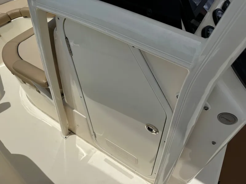 Slide: The Image of Close-up of a white boat cabin door with a beige seating area beside it. - 21