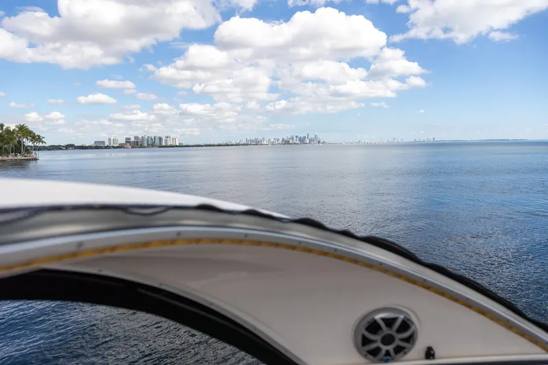 Slide: The Image of 2004 Meridian 411 Sedan yacht with city skyline and ocean view under blue sky. - 13