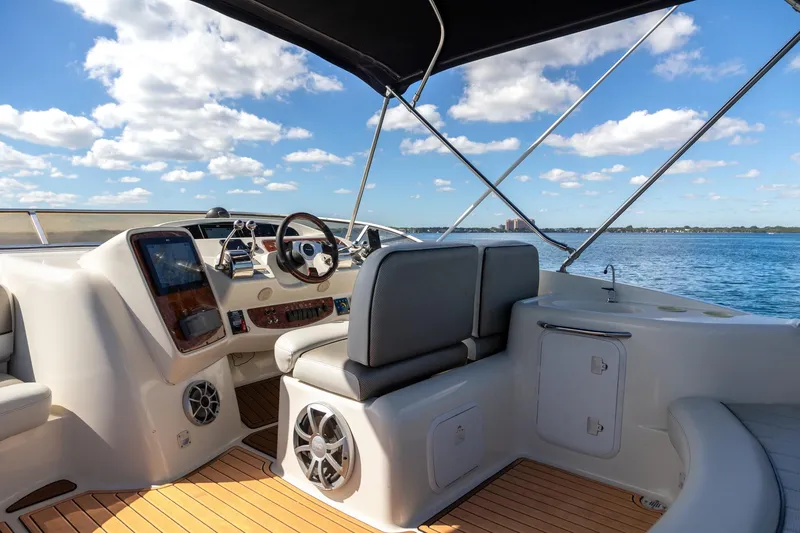 Slide: The Image of Luxurious 2004 Meridian 411 Sedan yacht interior with helm, overlooking serene blue waters. - 10
