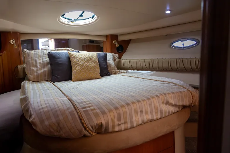 Slide: The Image of Luxurious cabin interior of a 2004 Meridian 411 Sedan yacht with plush bedding. - 20