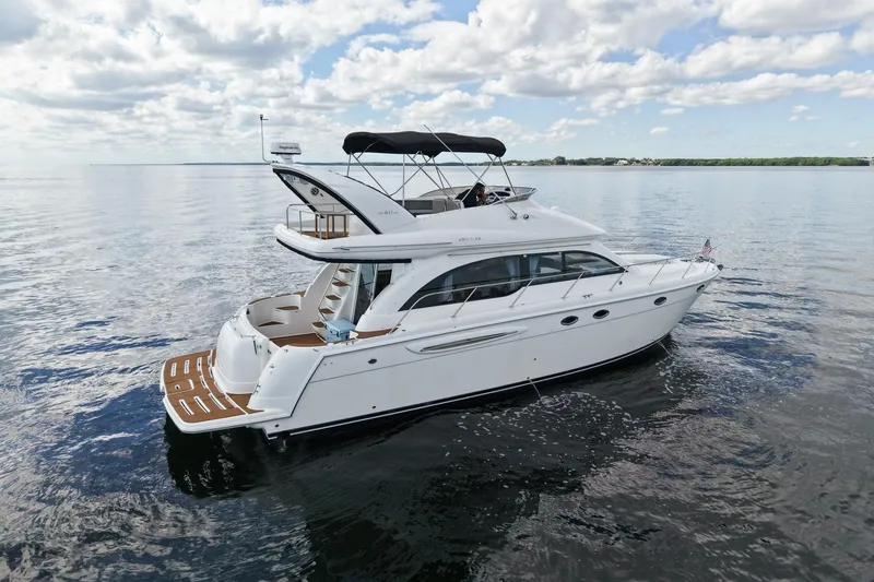 The Image of 2004 Meridian 411 Sedan yacht cruising on calm waters under a partly cloudy sky. - 0