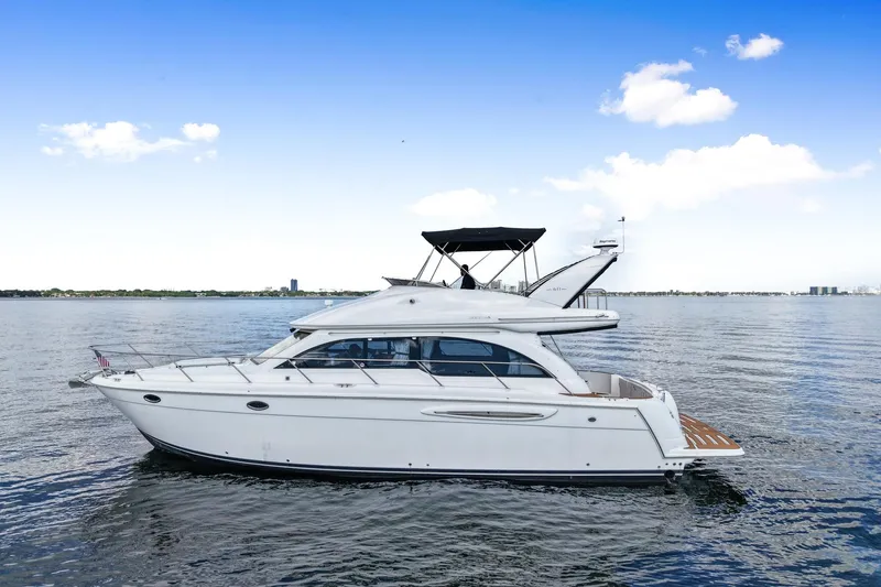 Slide: The Image of 2004 Meridian 411 Sedan yacht on calm water under a clear blue sky. - 3