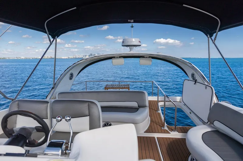 Slide: The Image of Luxurious 2004 Meridian 411 Sedan yacht interior with ocean view and modern seating. - 11