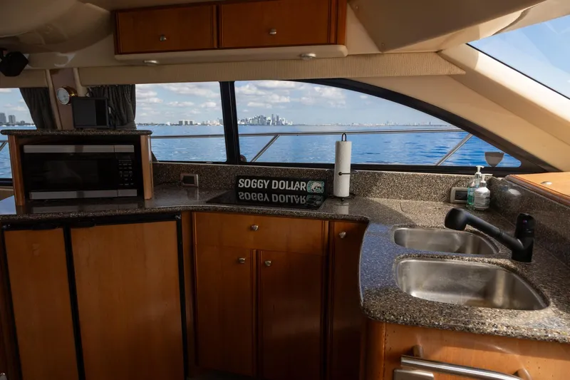 Slide: The Image of Interior of 2004 Meridian 411 Sedan yacht with kitchen view and ocean backdrop. - 18
