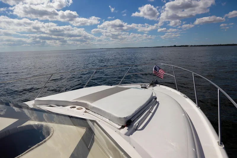 Slide: The Image of 2004 Meridian 411 Sedan yacht cruising on open water under a partly cloudy sky. - 7