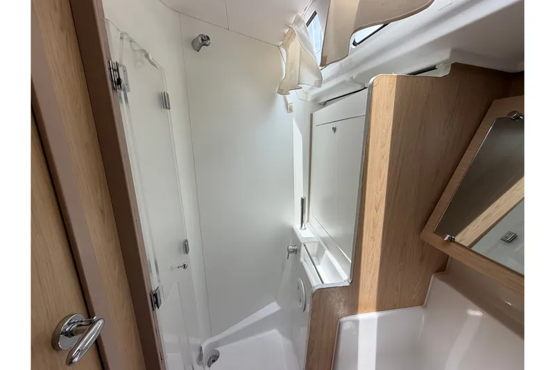 Slide: The Image of Bathroom interior of 2017 Beneteau Oceanis 45 yacht, featuring modern fixtures and wood accents. - 44