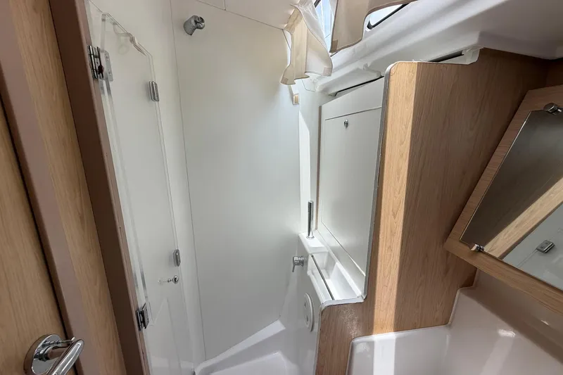 Slide: The Image of Interior of 2017 Beneteau Oceanis 45 yacht bathroom with modern fixtures and wood accents. - 46