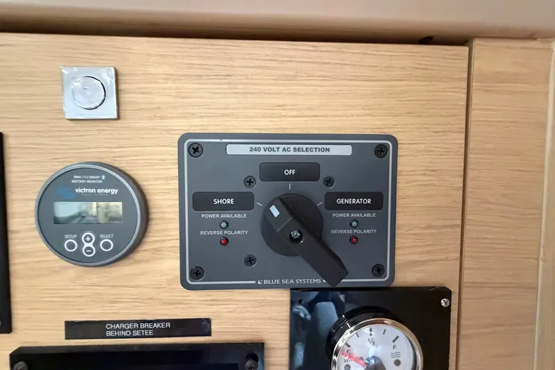 Slide: The Image of Control panel on a 2017 Beneteau Oceanis 45 yacht, featuring power selection switches. - 63