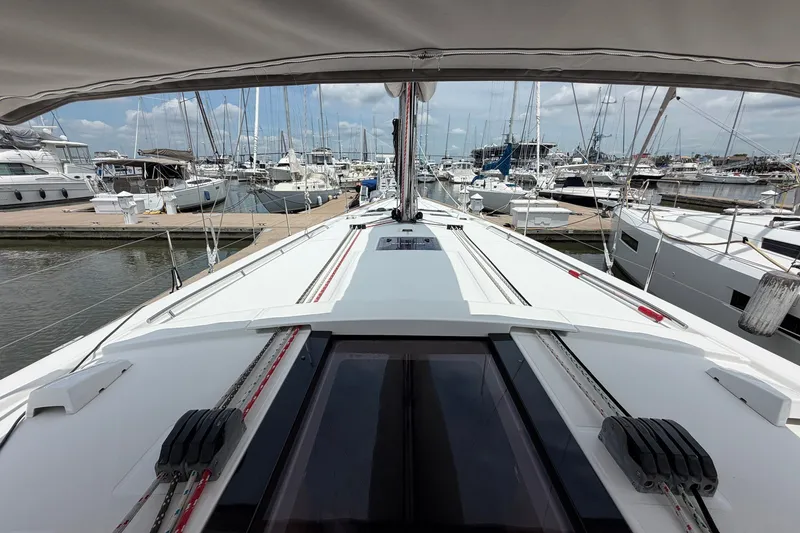 Slide: The Image of Beneteau Oceanis 45 sailboat docked at marina, showcasing sleek deck design, 2017 model. - 17