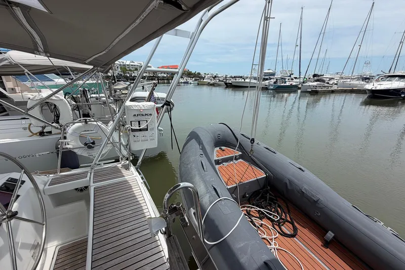 Slide: The Image of 2017 Beneteau Oceanis 45 sailboat docked with inflatable dinghy, marina view. - 24