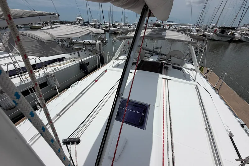 Slide: The Image of 2017 Beneteau Oceanis 45 sailboat docked at marina, showcasing deck and rigging. - 16