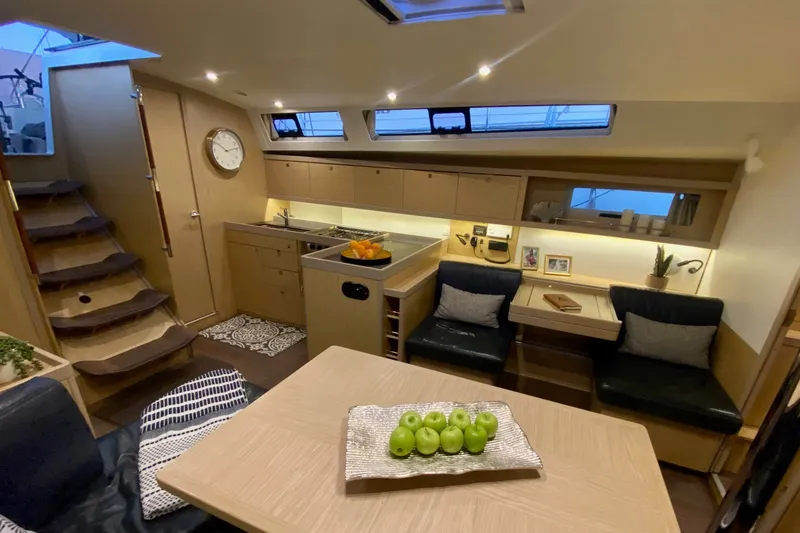 Slide: The Image of Luxurious interior of 2017 Beneteau Oceanis 45 yacht with modern kitchen and seating area. - 34