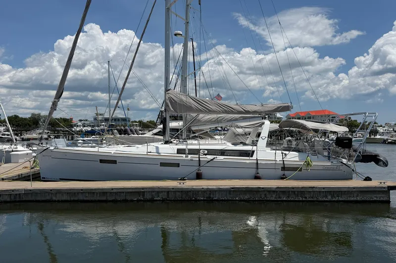 Slide: The Image of 2017 Beneteau Oceanis 45 sailboat docked at marina under blue sky. - 4