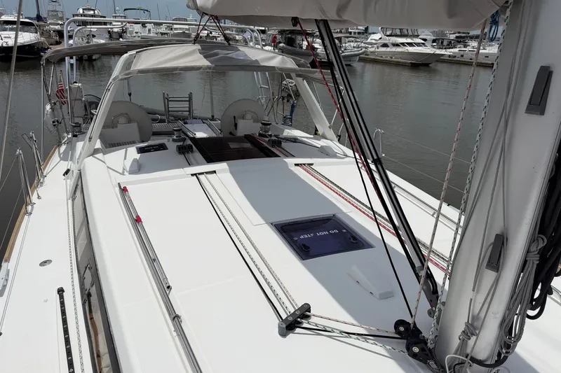 Slide: The Image of 2017 Beneteau Oceanis 45 sailboat deck view at marina, showcasing sleek design and rigging. - 13