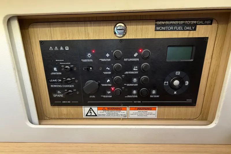 Slide: The Image of Control panel of a 2017 Beneteau Oceanis 45 sailboat, featuring various switches and indicators. - 56