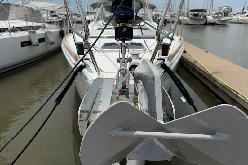 Slide: The Image of 2017 Beneteau Oceanis 45 yacht anchored at marina, showcasing anchor and bow details. - 7
