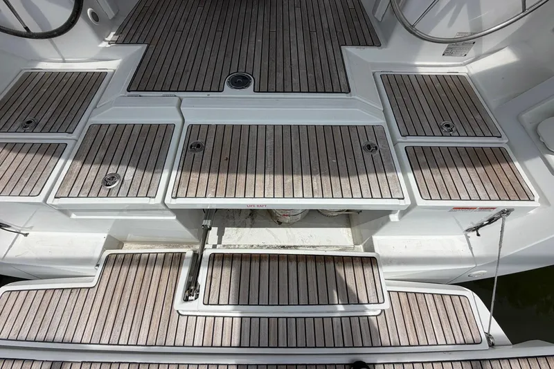 Slide: The Image of Beneteau Oceanis 45 (2017) yacht deck with teak flooring and storage compartments. - 27