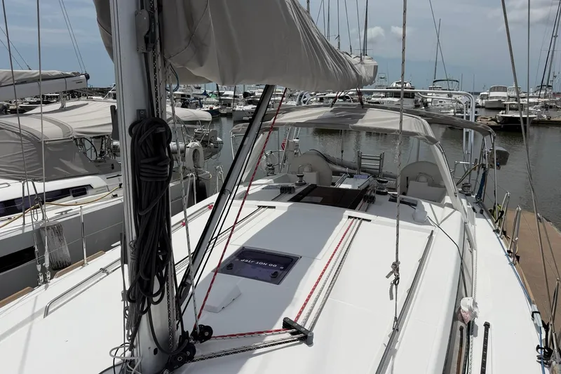 Slide: The Image of 2017 Beneteau Oceanis 45 sailboat docked at marina, showcasing deck and rigging. - 11