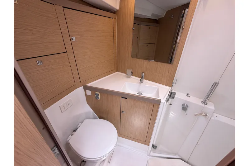 Slide: The Image of Beneteau Oceanis 45 2017 yacht bathroom with modern fixtures and wood cabinetry. - 38
