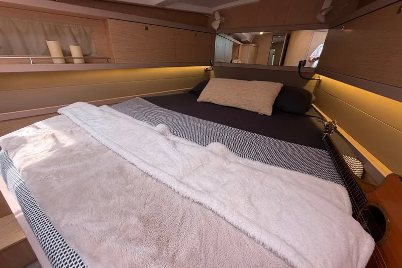 Slide: The Image of Cozy cabin interior of 2017 Beneteau Oceanis 45 yacht with bed and guitar. - 39