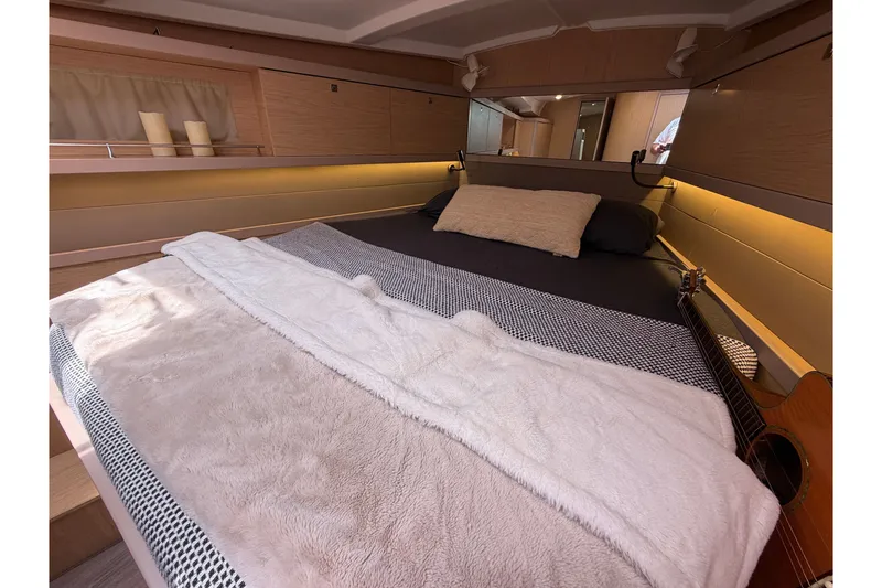 Slide: The Image of Cozy bedroom interior of 2017 Beneteau Oceanis 45 yacht with guitar and soft lighting. - 36