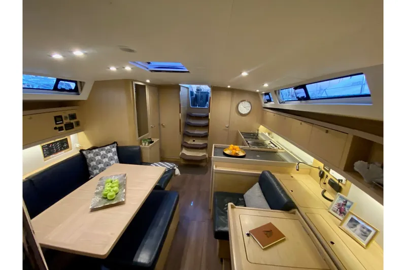 Slide: The Image of Luxurious interior of 2017 Beneteau Oceanis 45 yacht with modern kitchen and dining area. - 29