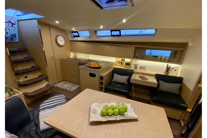 Slide: The Image of Interior of 2017 Beneteau Oceanis 45 yacht, featuring modern kitchen and cozy seating area. - 31