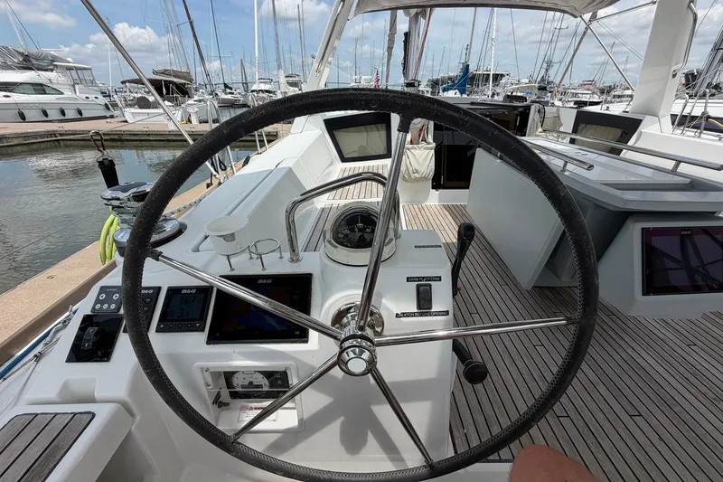 Slide: The Image of Cockpit view of a 2017 Beneteau Oceanis 45 sailboat at a marina. - 29