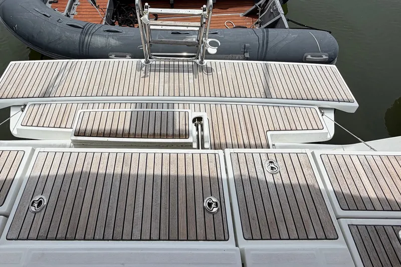 Slide: The Image of Beneteau Oceanis 45 (2017) yacht deck with wooden finish and ladder. - 27