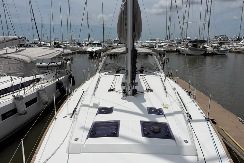 Slide: The Image of 2017 Beneteau Oceanis 45 sailboat docked in a marina, surrounded by other boats. - 11