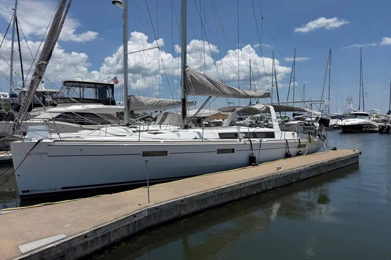 Slide: The Image of 2017 Beneteau Oceanis 45 sailboat docked at marina under blue sky. - 3