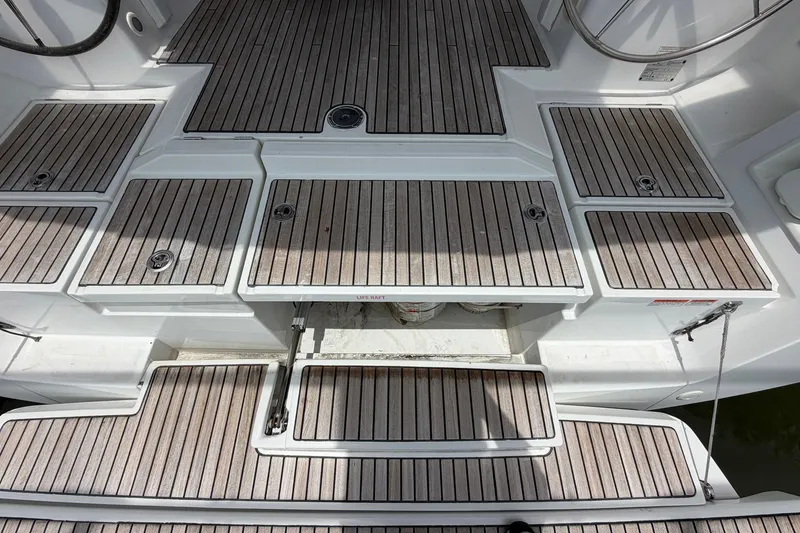 Slide: The Image of Beneteau Oceanis 45 (2017) yacht deck with teak flooring and storage compartments. - 28