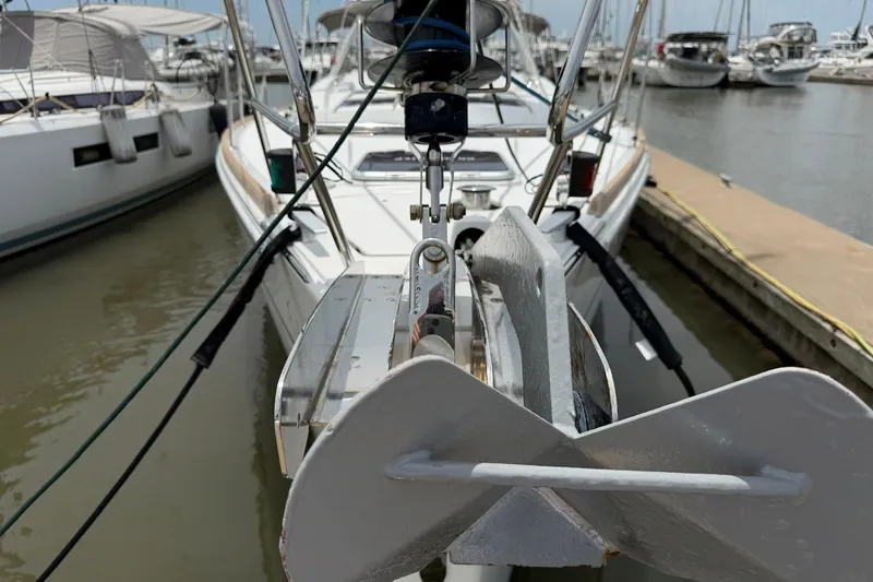 Slide: The Image of Beneteau Oceanis 45 sailboat anchored at marina, showcasing anchor and bow details. - 8